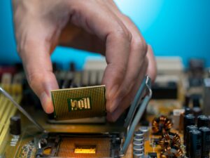 Electronic engineer hand putting computer chip on socket. Chipset on electronic circuit board of PC