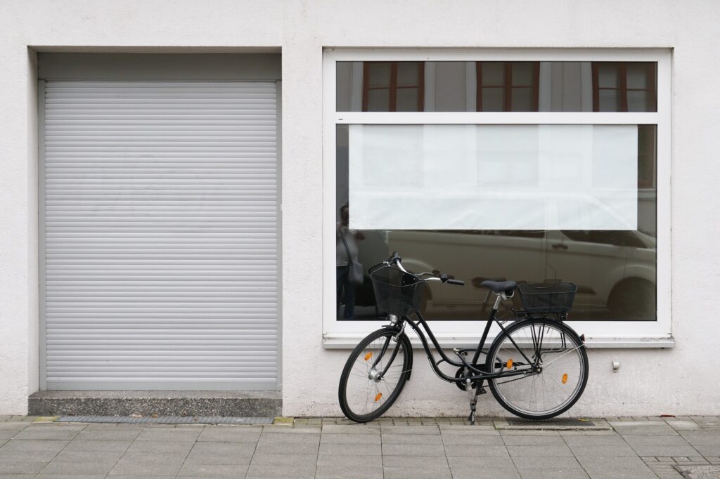 blank vacancy sign or poster in empty store window with bicycle parked outside closed shop